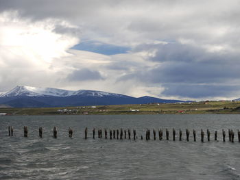 Scenic view of lake by mountains against sky