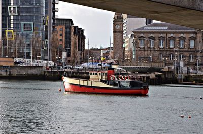 Boats in canal with buildings in background