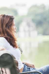 Beautiful woman relaxing at hoan kiem lake in hanoi / vietnam