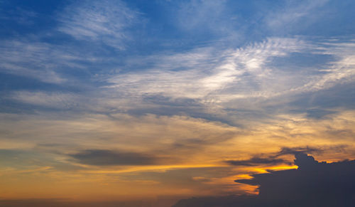 Low angle view of silhouette building against dramatic sky