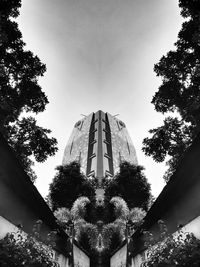 Low angle view of trees and buildings against sky