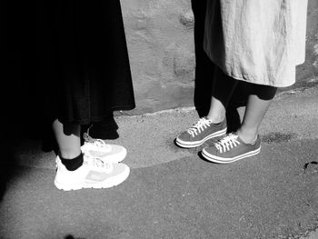 Low section of women standing on road