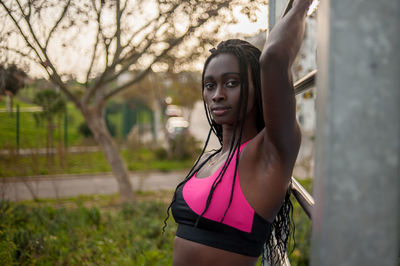 Portrait of young woman standing outdoors