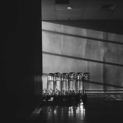 Empty luggage carts arranged by wall