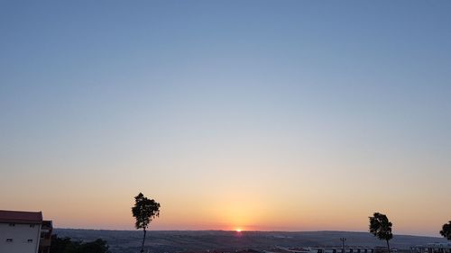 Scenic view of sea against clear sky during sunset