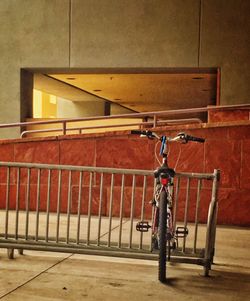 Close-up of bicycle hanging on railing