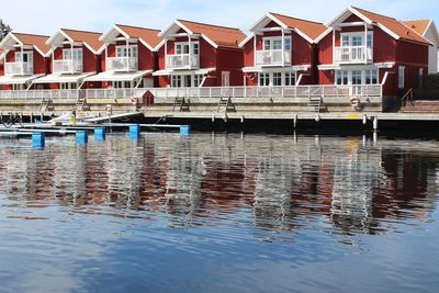 Boats moored in lake against buildings