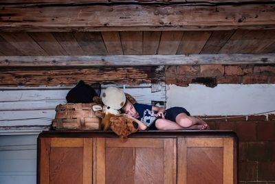 Rear view of kid lying on closet