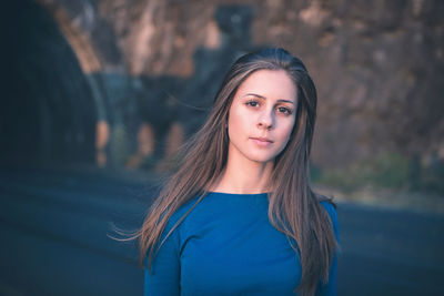 Girl in a blue long sleeve shirt on a street. golden hour portrait.