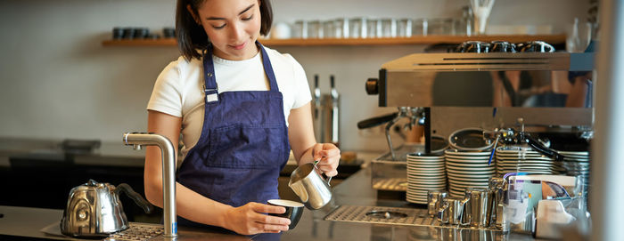 Portrait of young woman sitting in cafe