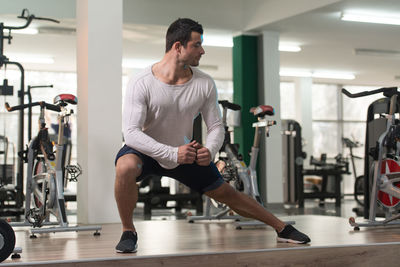 Muscular man exercising in gym