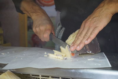 Midsection of man working in kitchen