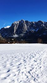 Snowcapped mountains against clear blue sky