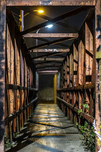 Empty corridor in illuminated building