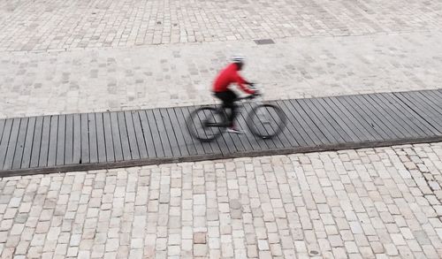 Blurred motion of people walking on road