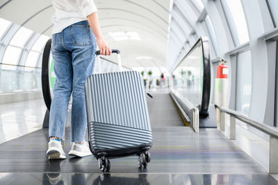 Low section of man standing at airport