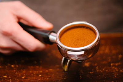 Close-up of hand holding coffee cup