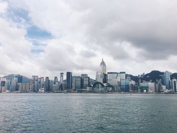 Hong kong skyline against cloudy sky