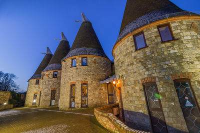 Old building against clear blue sky in city