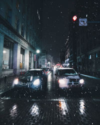 Illuminated city street during rainy season at night