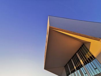 Low angle view of modern building against clear blue sky