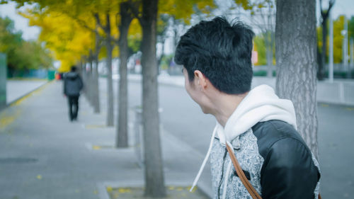 Side view of woman standing on street