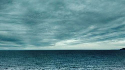 Scenic view of sea against cloudy sky