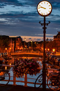 Illuminated street lights in city at night