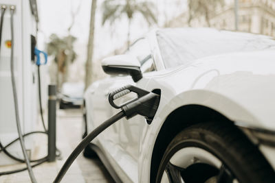 White electric car at charging station