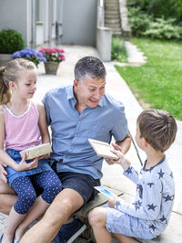 Family giving gifts to each other at yard