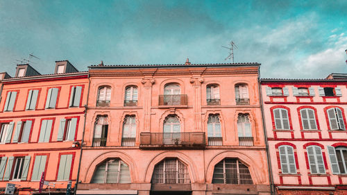 Low angle view of building against cloudy sky