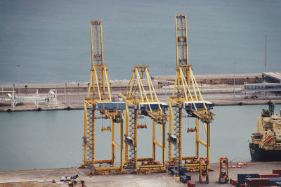 Cranes at construction site against sky