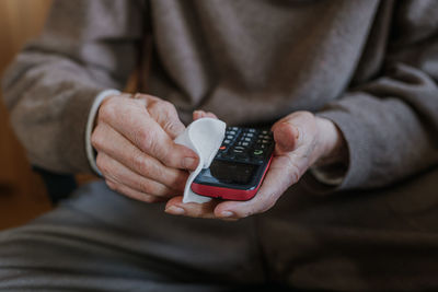 Midsection of man holding camera