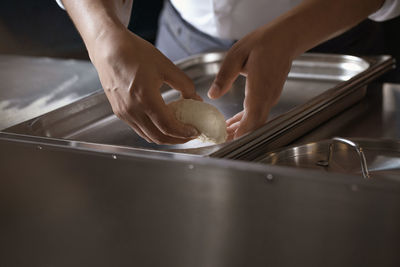 Midsection of man preparing food in kitchen