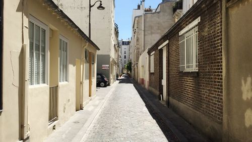 Narrow alley amidst buildings in city