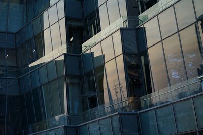 Low angle view of glass building in city