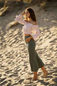 Full length of woman standing on beach