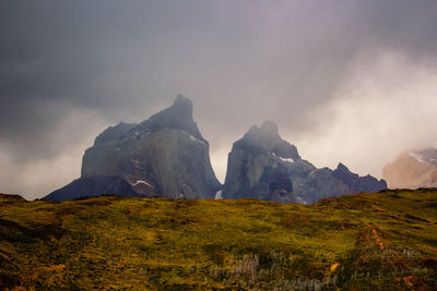 Scenic view of mountains against cloudy sky