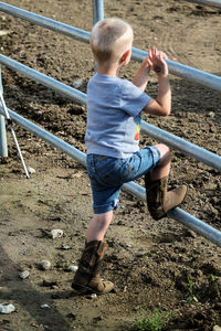 Boy playing on railing