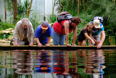 Rear view of people enjoying in water