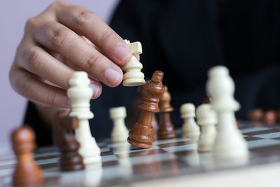 Close-up of man playing with chess