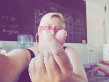 Close-up portrait of woman gesturing in classroom