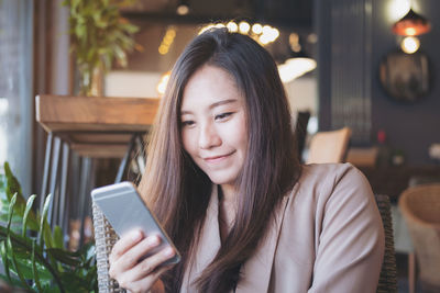 Portrait of young woman using mobile phone