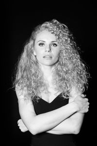 Portrait of a beautiful young woman over black background