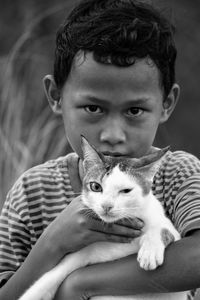 Portrait of boy with cat