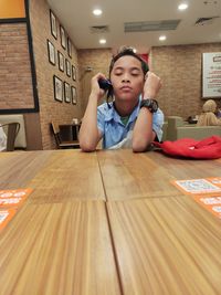 Portrait of boy sitting on table