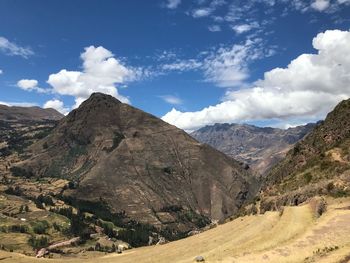 Scenic view of rocky mountains against blue sky