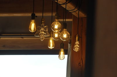 Illuminated light bulbs hanging at home