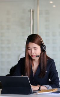 Businesswoman using laptop at office