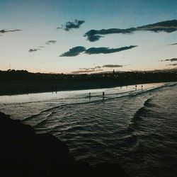 Scenic view of lake against sky at sunset